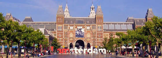 front of the Rijksmuseum with the IAmsterdam logo in front of it on a sunny day in The Netherlands