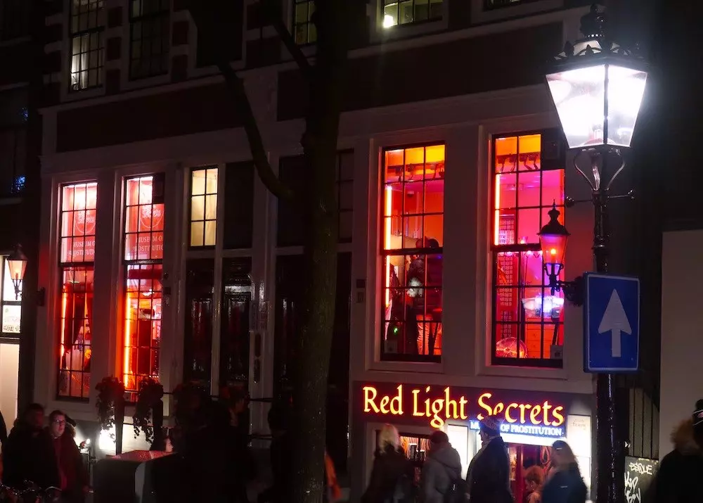 the Red Light Secrets Museum of Prostitution facade at night in Amsterdam's Red Light District