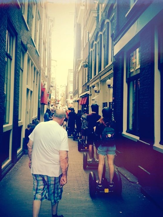People are getting a Segway tour in Amsterdam's Red Light District
