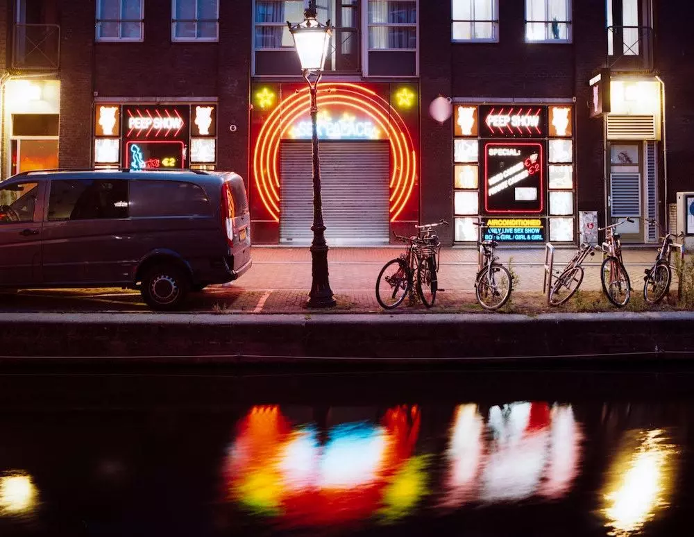 Sex Palace peep show lit up at night on the Oudezijds Achterburgwal in Amsterdam's Red Light District