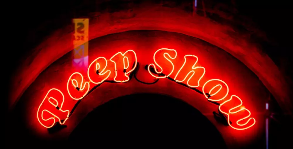 Red neon Peep Show sign at Sex Palace in Amsterdam's Red Light District