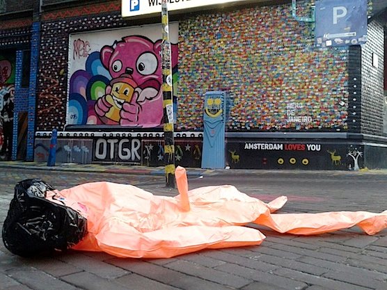 Street Art in Amsterdam: Inflatable Doll in front of the art work of Ottograph.