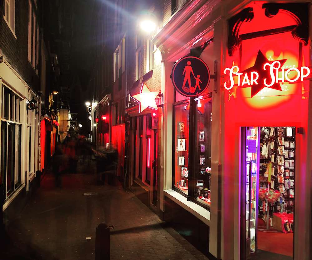 a red-lit alley in Amsterdam Red Light District