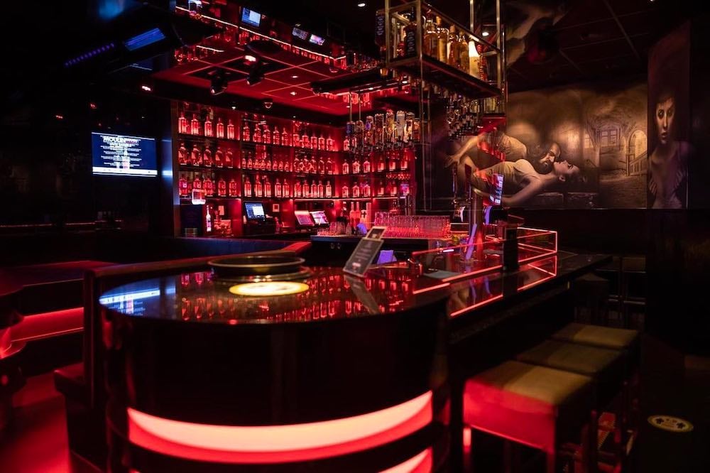 The trendy bar inside Moulin Rouge in Amsterdam and chairs around it