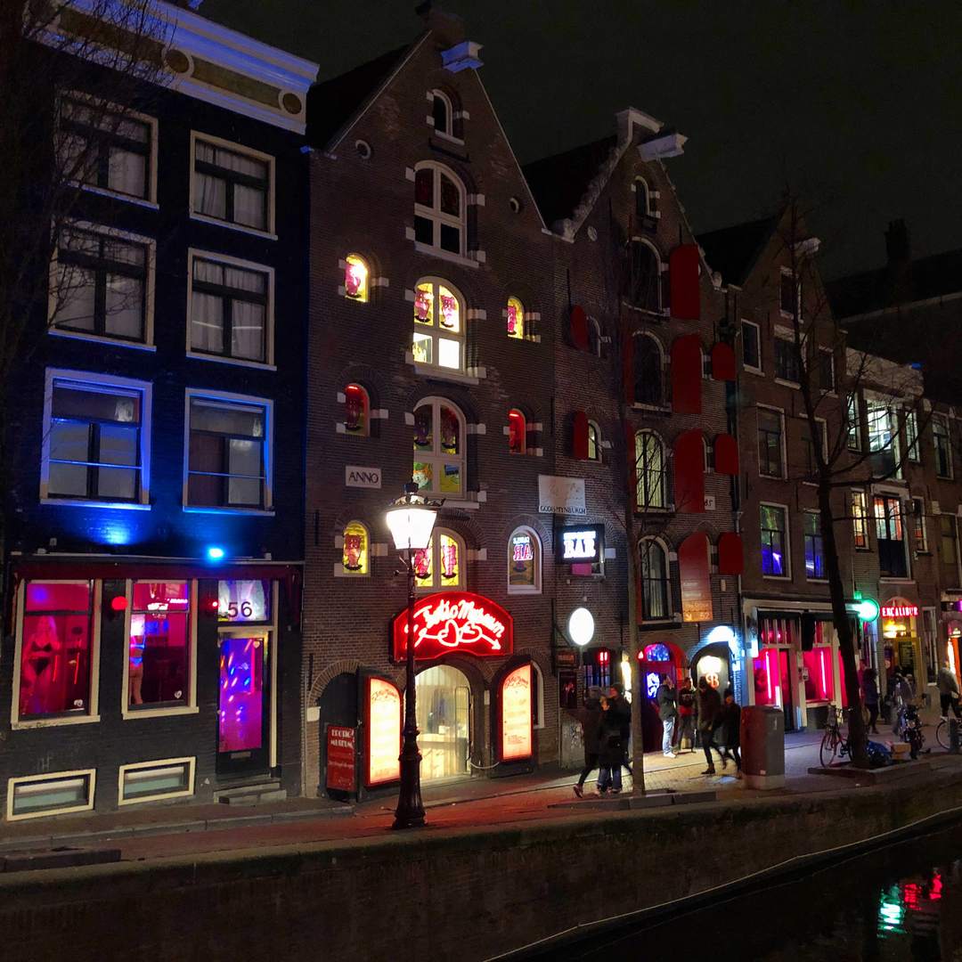 Red and blue lit window brothels and the Erotic Museum on Oudezijds Achterburgwal in Amsterdam at night